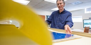 Person looking through large flat file folder of architectural special collections materials