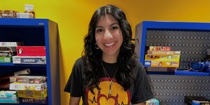 Portrait of Natalie Robles in front of the game section at the Downtown Phoenix campus Library