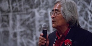 Simon J. Ortiz speaking into a microphone