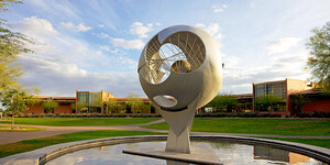 The majestic Continents sculpture, a gift of the Class of 1960, stands in front of the Thunderbird library, known as the International Business Information Centre or IBIC.